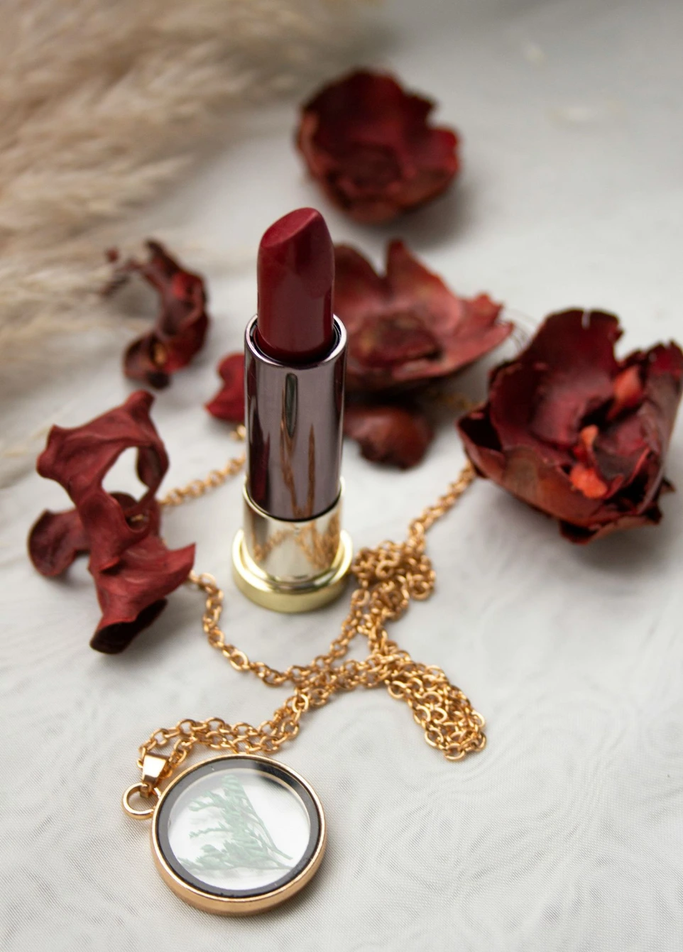 red lipstick on white textile